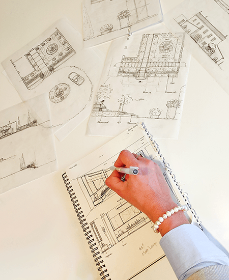 Hand makes architectural drawings for a construction company